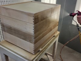 Drawer box being sprayed